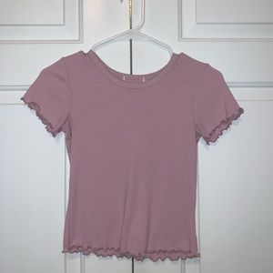 Pink tee shirt with ruffles on sleeve and bottom